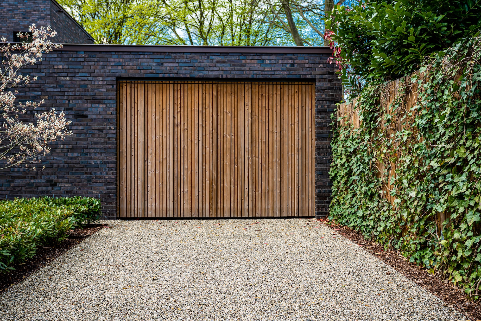 wide garage door and concrete driveway in front